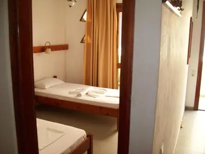 a small room with a bed and a mirror at Kato Stalos Beach in Stalos