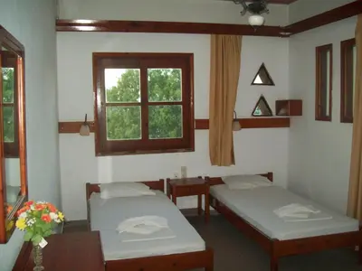 a hospital room with two beds and a window at Kato Stalos Beach in Stalos