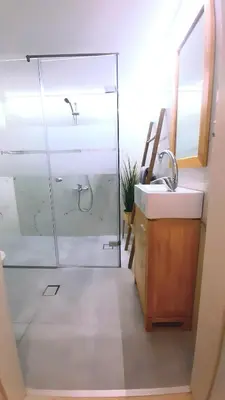 a bathroom with a glass shower and a sink at Apartment Split Level in Chania Town
