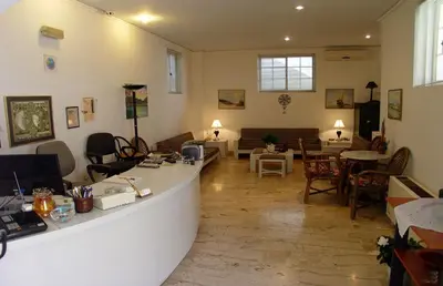 a living room with a counter and a table and chairs at Doreen Suites in Kalamaki Chanion