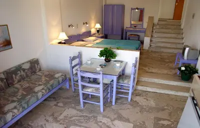 a small room with a table and a bed at Doreen Suites in Kalamaki Chanion