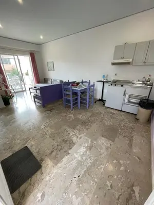a kitchen with a table and a stove and a counter at Doreen Suites in Kalamaki Chanion