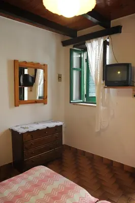 a bedroom with a bed and a tv on the wall at Eleonora in Chania Town
