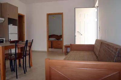 a living room with a couch and a table at Evilion hotel in Stalos