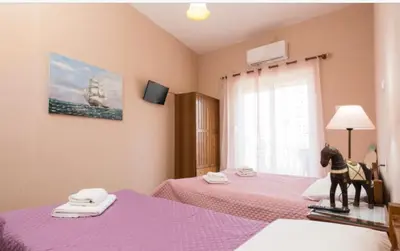 a dog standing on a bed in a bedroom at Eleni in Kissamos