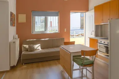 a small living room with a couch and a table at In And Out in Chania Town
