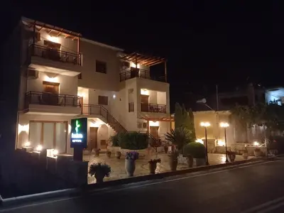 a building with a traffic light in front of it at night at Kandania Apartments in Kántanos