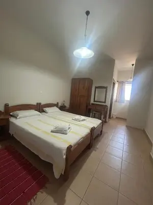 a bedroom with a large bed in a room at Kandania Apartments in Kántanos