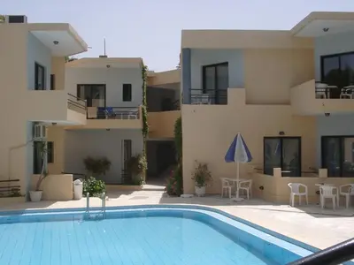 a swimming pool in front of a apartment building at Akasti Hotel in Kalamaki Chanion