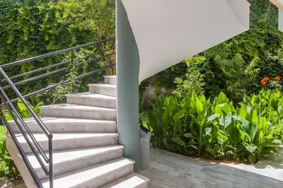 a staircase leading up to a house with plants at Akasti Hotel in Kalamaki Chanion