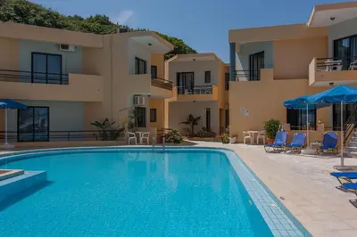 a swimming pool in front of a building at Akasti Hotel in Kalamaki Chanion