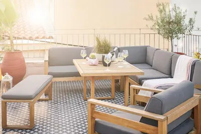a patio with couches and a table with wine glasses at Estia Residence in Chania Old Town in Chania Town