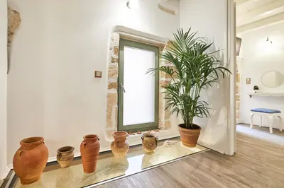 a room with a potted plant and a window at Estia Residence in Chania Old Town in Chania Town