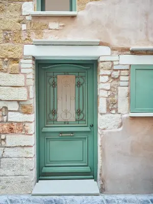 a green door in a brick building at Estia Residence in Chania Old Town in Chania Town