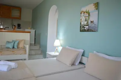 a bedroom with a bed and a bed and a stairway at Sofia Kalyves in Kalyves