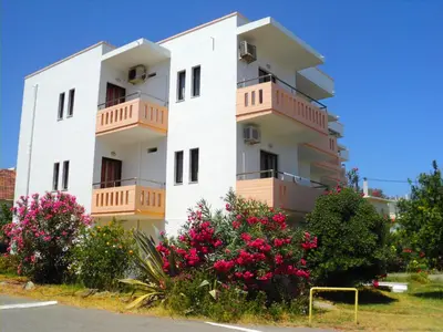 a white building with pink flowers in front of it at Thodorou Villa in Agia Marina Nea Kydonias