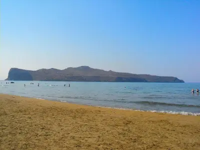 a group of people swimming in the water on a beach at Thodorou Villa in Agia Marina Nea Kydonias