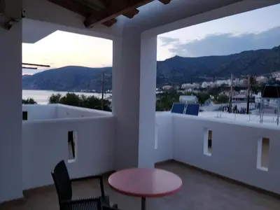 a view from the balcony of a house with a table and chairs at Sifis Studios in Palaiochóra