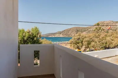 a view of the beach from the balcony of a house at Sifis Studios in Palaiochóra