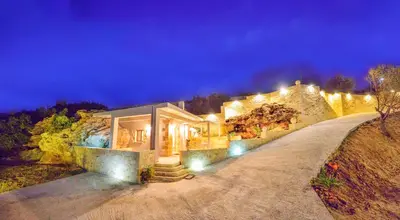 a house with lights on the side of a road at Koukis House With Sea View in Falasarna