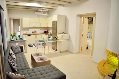 a living room with a couch and a kitchen at Koukis House With Sea View in Falasarna