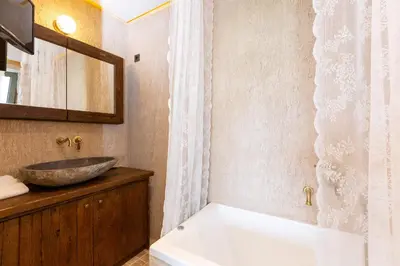 a bathroom with a sink and a tub and a sink at Elements Villa in Galangádhos