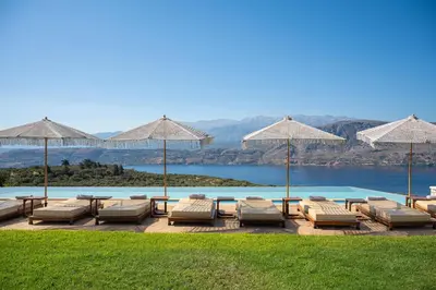 a group of lounge chairs and umbrellas on a patio at Elements Villa in Galangádhos