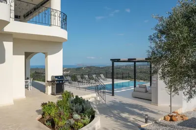 a villa with a view of a swimming pool at Luxury Apartment with private pool in Tavronitis