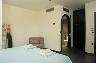 a bedroom with a bed with two towels on it at Luxury Apartment with private pool in Tavronitis