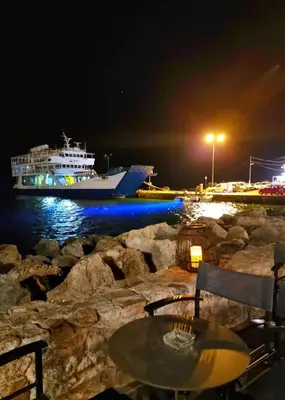 a cruise ship in the water at night at Yiorgos Studios in Palaiochóra