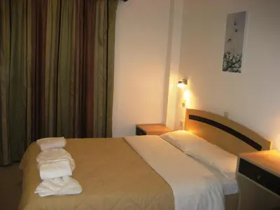 a hotel room with a bed with towels on it at Yiorgos Studios in Palaiochóra