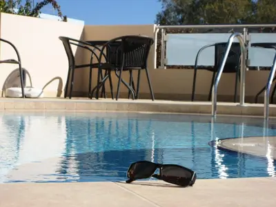 a pair of sunglasses sitting in a swimming pool at Yiorgos Studios in Palaiochóra