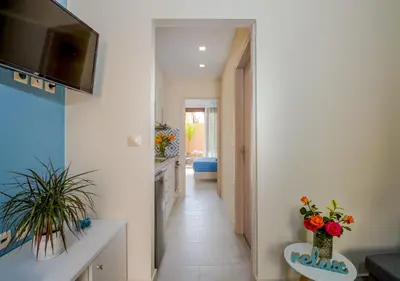 a hallway of a home with two vases with flowers at Aretousa Suites in Chania Town