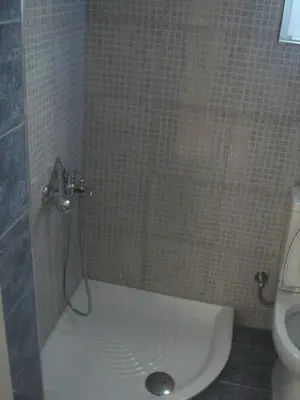 a shower in a bathroom with a toilet at Neapolis Apartments in Palaiochóra