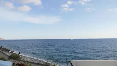 a view of the ocean with a boat in the distance at Zorbas Studios in Agia Roumeli