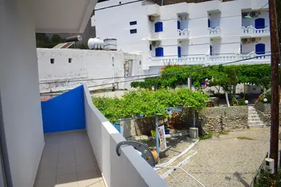 a balcony with a view of a building at Zorbas Studios in Agia Roumeli