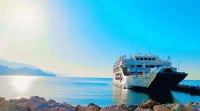 a boat is docked at a dock in the water at Haris Studios in Palaiochóra