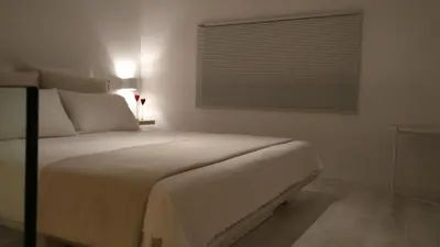 a bedroom with a large white bed with a window at Sixteen All Seasons House in Chania Town