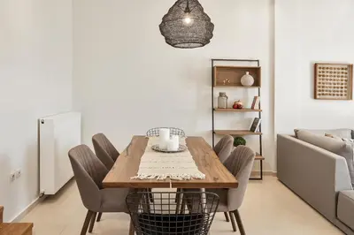 a dining room with a wooden table and chairs at Villa Anemi in Stérnai