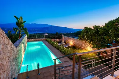 a swimming pool in a villa at night at Villa Anemi in Stérnai
