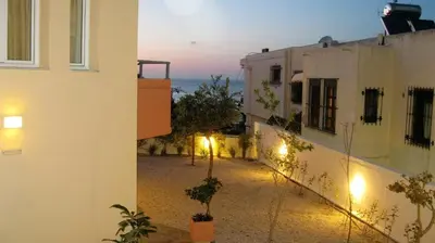 a view of an alley between two buildings at night at Iolkos Hotel Apartments in Kato Daratso