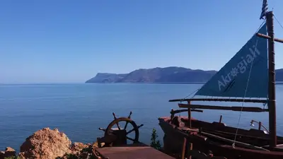 a boat sitting on the side of a body of water at Akrogiali in Kissamos