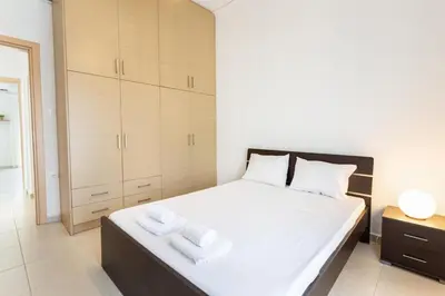 a bedroom with a bed with white towels on it at Mirsini's Apartment in Chania center in Chania Town