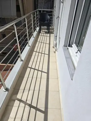 a chair sitting on a balcony with its shadows at Mirsini's Apartment in Chania center in Chania Town