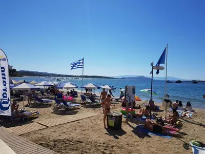 a group of people on a beach with the water at Mirsini's Apartment in Chania center in Chania Town