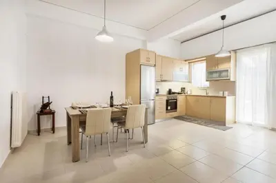 a kitchen and dining room with a table and chairs at Mirsini's Apartment in Chania center in Chania Town
