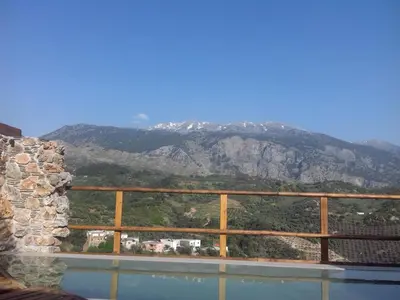 a view of a mountain from a swimming pool at Villa Aeolus with private overflow, endless, heated pool in Prinés