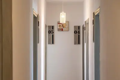 a hallway with four pictures on the wall at Giannis Rooms in Agia Roumeli