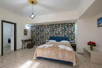a bedroom with a large bed with a colorful wall at Areti Suites in Kathiana