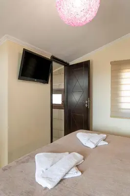 a bedroom with a bed with two towels on it at Areti Suites in Kathiana